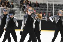 A group of skaters with face paint doing a dance routine